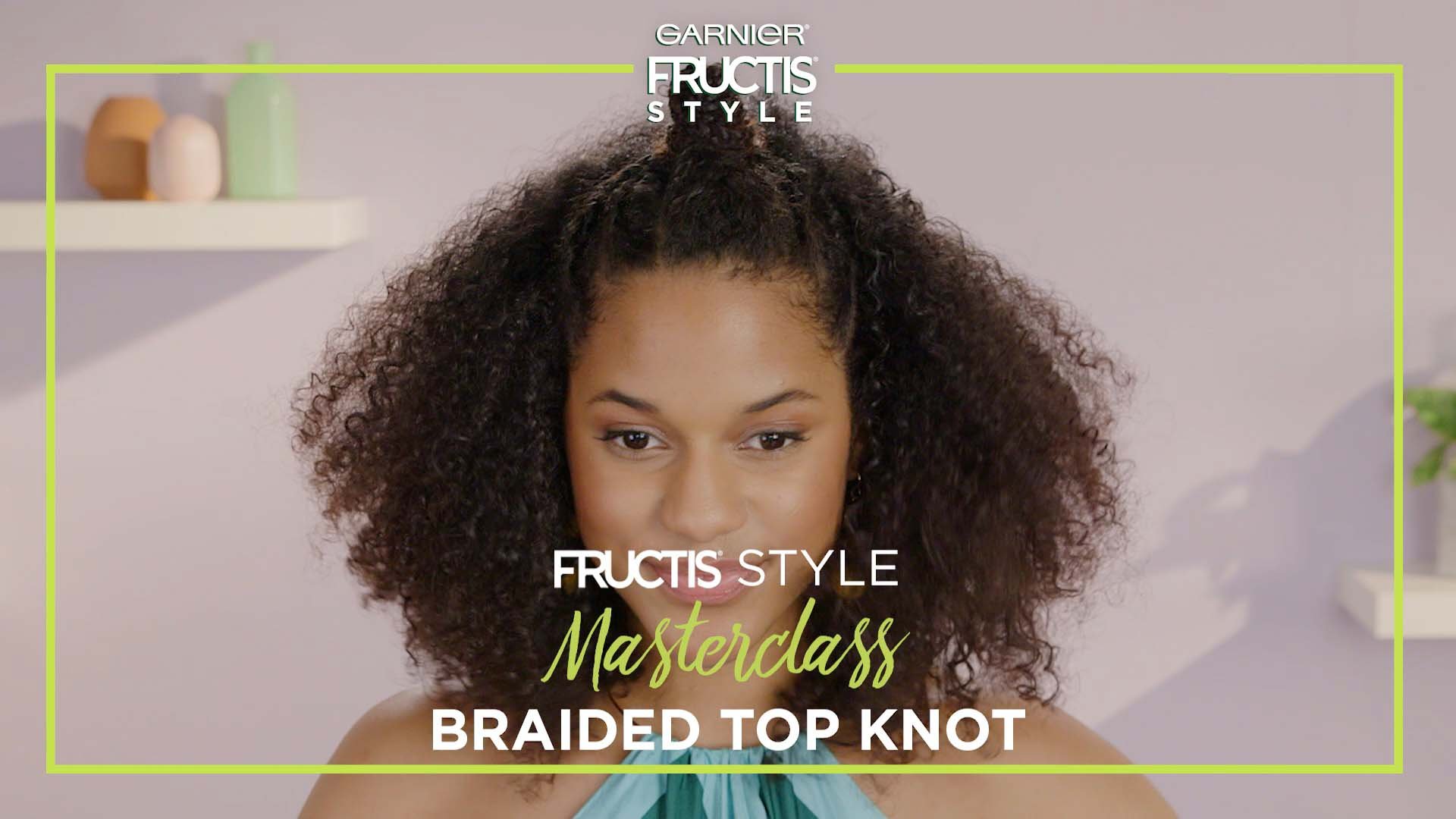 Girl looking at camera with Braided Top Knot hairstyle.
